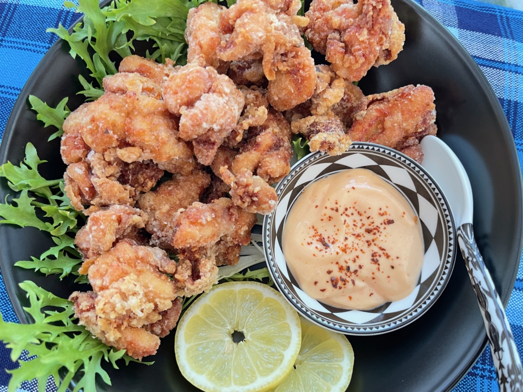 Once all chicken pieces have been crisped up, transfer chicken to a platter or bowl, garnish as desired and serve with Sriracha Mayo.